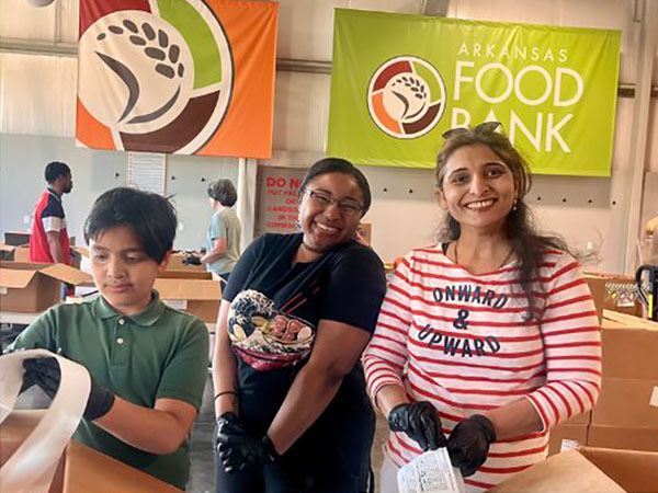 A photo of Euronet Software Solutions employees serving at the Arkansas Food Bank