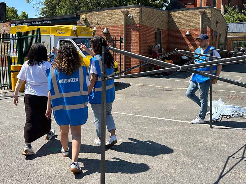 Euronet employees volunteering at King Solomon Academy summer fair in London