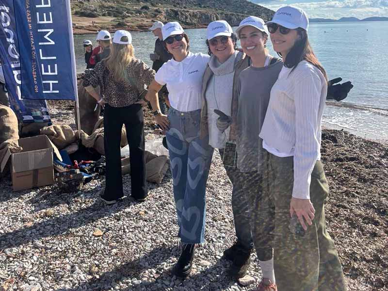 Volunteers participating in a beach clean-up at Varkiza Beach in the Athens area to protect marine life and reduce pollution.